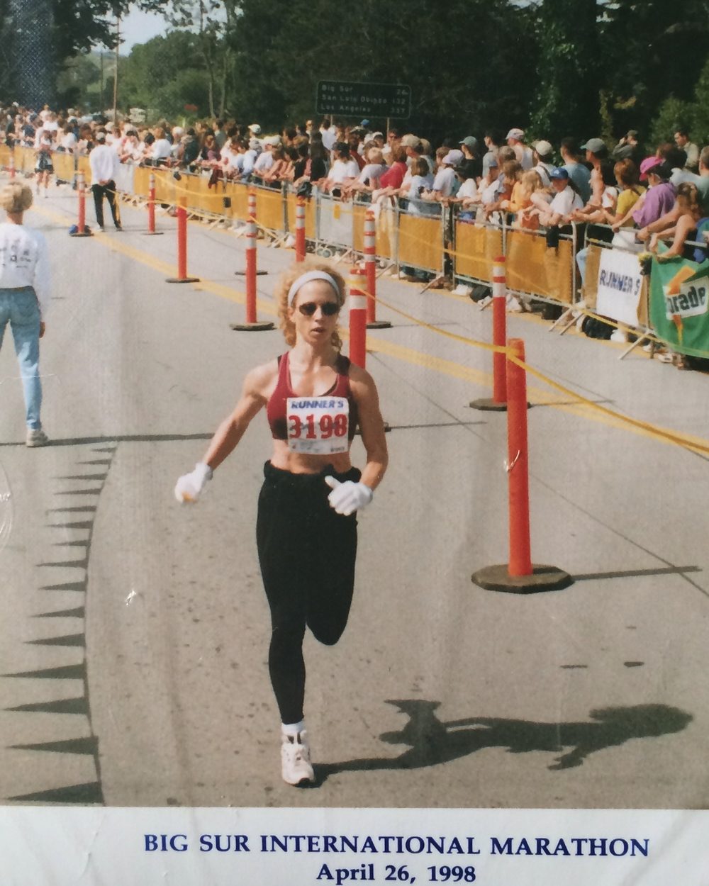 Loree running past the crowd at the Big Sur International Marathon, race number pinned to her top
